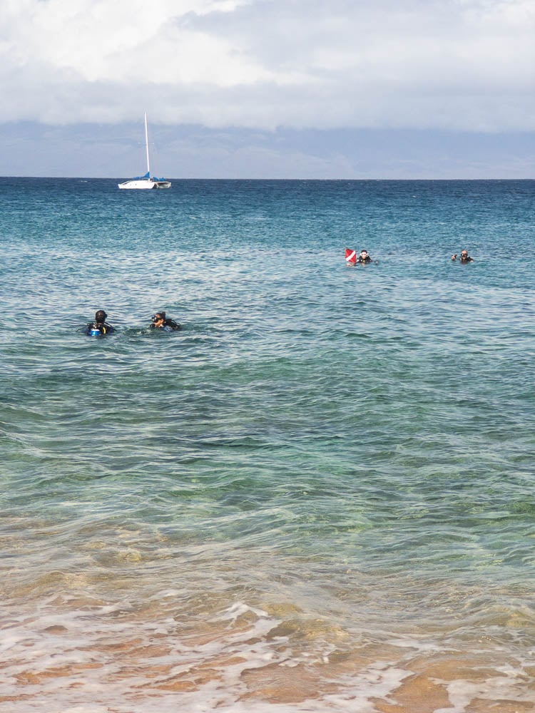 Scuba divers in the water at Airport Beach in Maui, Hawaii