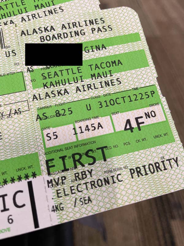 Close up of a printed boarding pass for a first class Alaska Airlines passenger