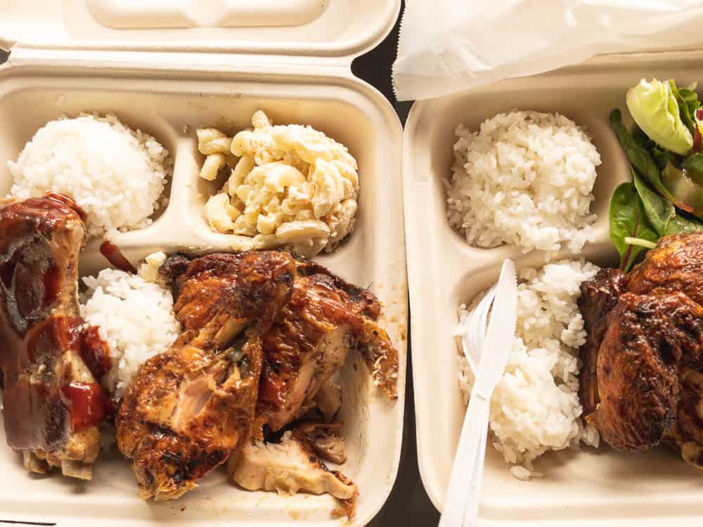 Top down view of huli huli chicken plates with rice and mac salad
