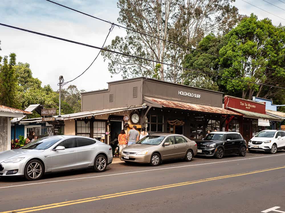 Exterior view of shops in plantation era buildings at Makawao, Maui with cars parked on the street