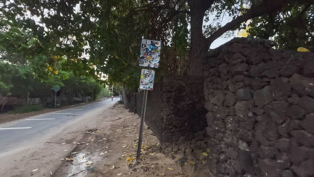 Street view of the lava rock wall at the entrance to Makena Cove