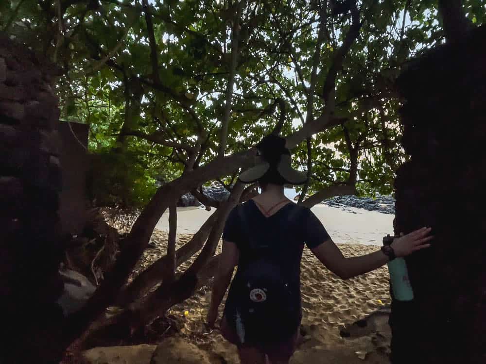 A woman walks toward the beach at the entrance to Makena Cove