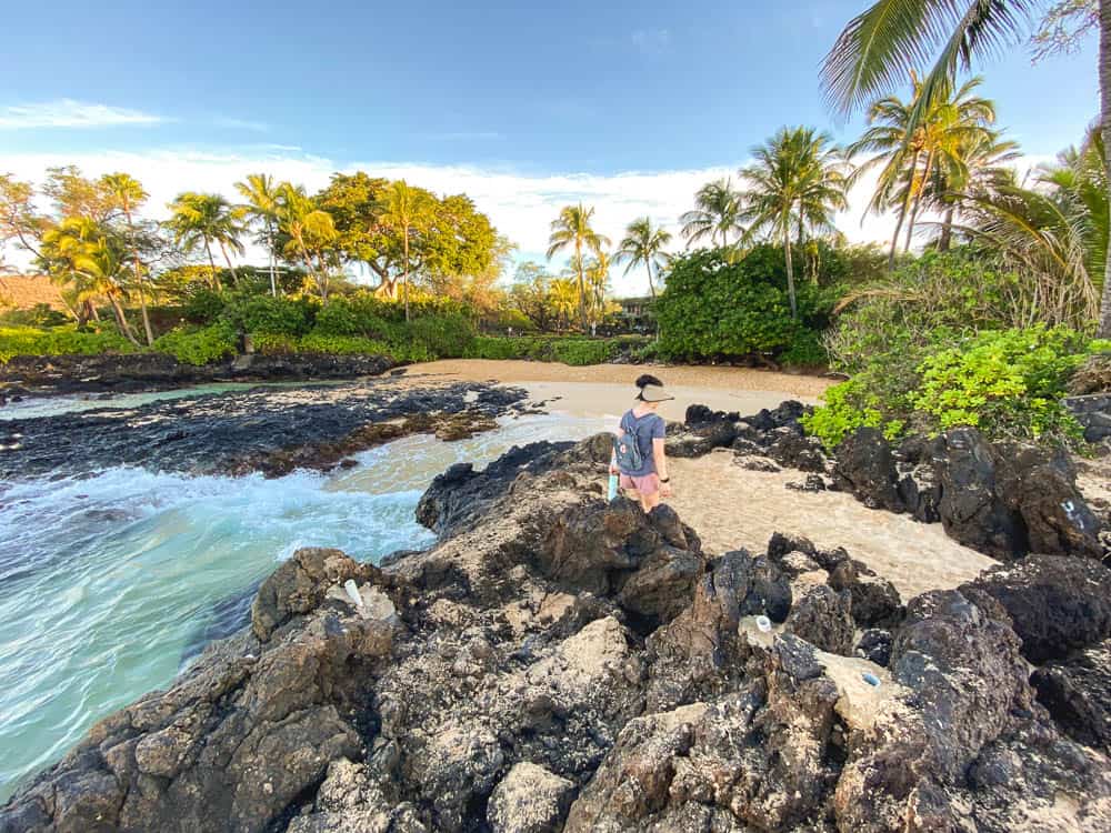 A woman walking onto the beach at Makena Cove in Maui Hawaii