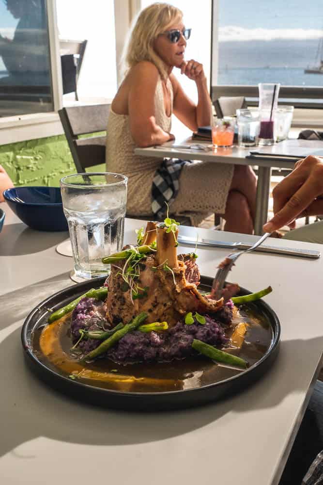 Plated entree with a view of the ocean at Mala Ocean Tavern, Lahaina Maui