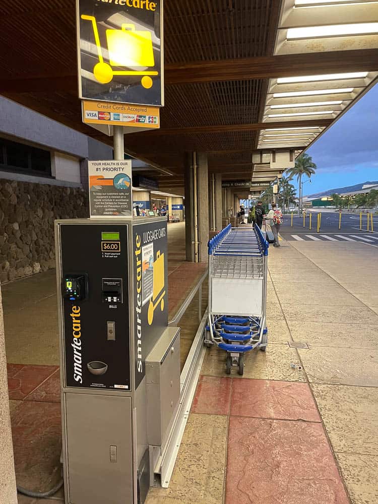 A line of luggage carts available for rent at Maui's Kahului Airport