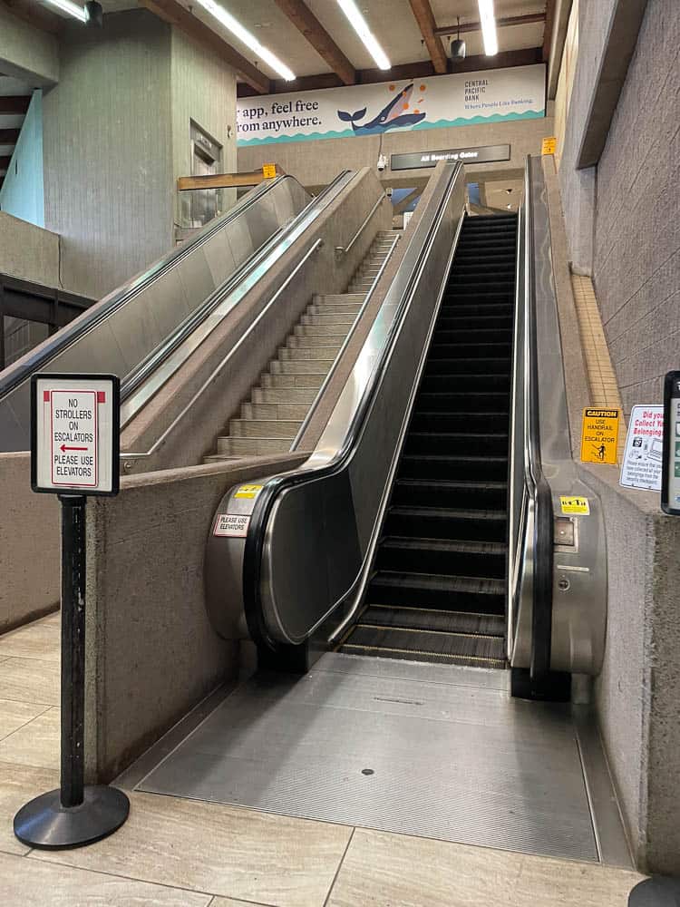 Escalator leading to the main terminal gates at Maui's Kahului Airport (OGG).