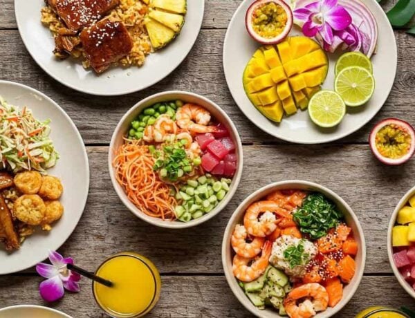 A colorful array of Hawaiian dishes on a wooden table
