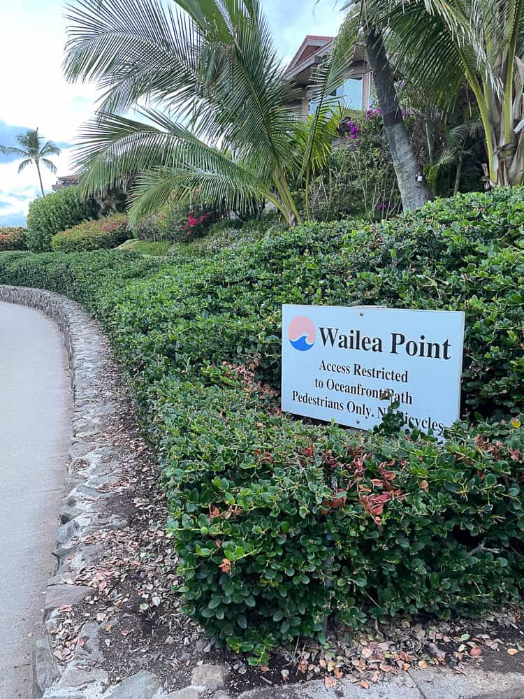 A sign at Wailea Point along the Wailea Beach Path noting restricted access to oceanfront path pedestrians only.